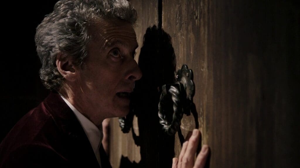 The 12th Doctor, up against a door