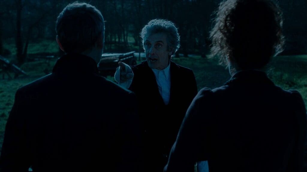 The Twelfth Doctor, talking to The Saxon Master and Missy. He is angry and pointing