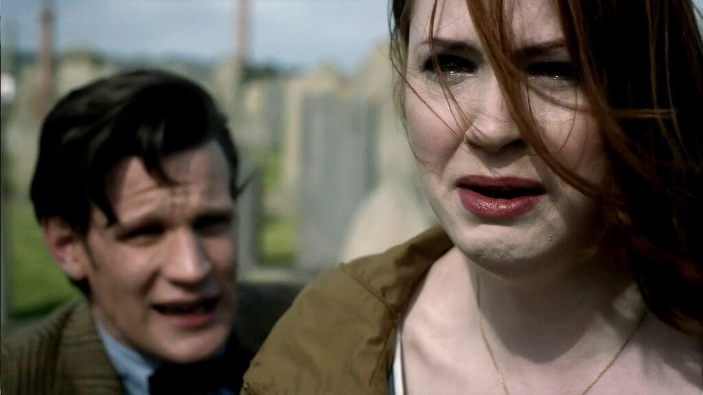 Amy, crying, turns away from the Doctor