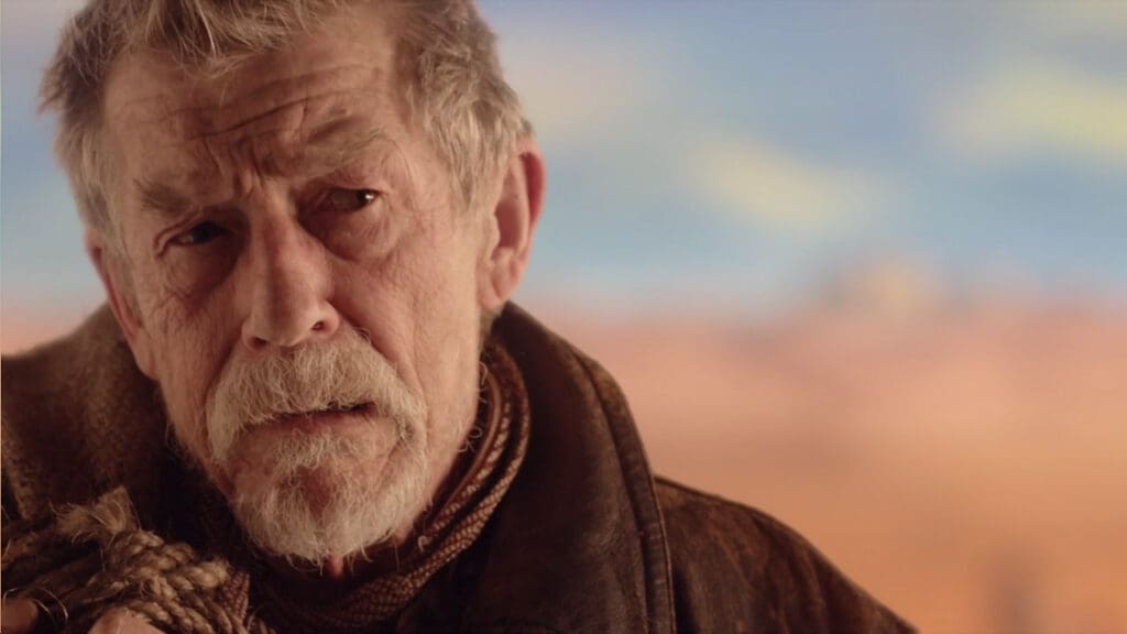 The War Doctor, carrying a sack, in the deserts of Gallifrey