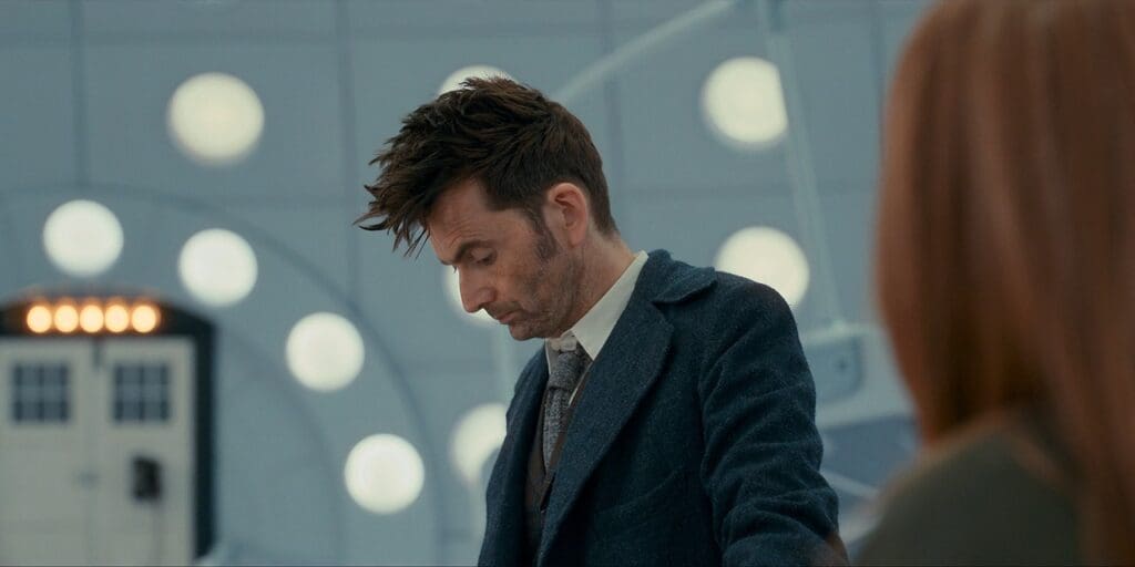 The Doctor in the TARDIS, looking sad