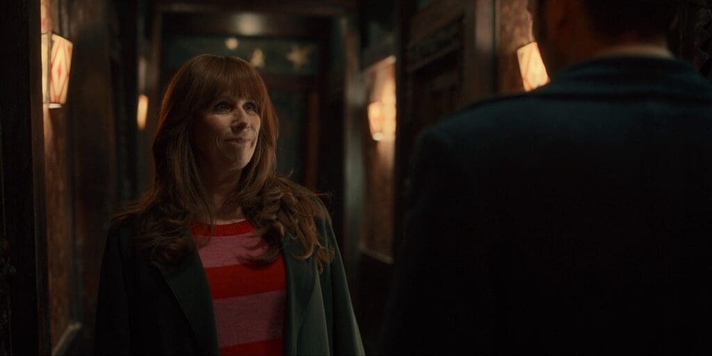 Donna, smiling at The Doctor. They are in the toyshop.