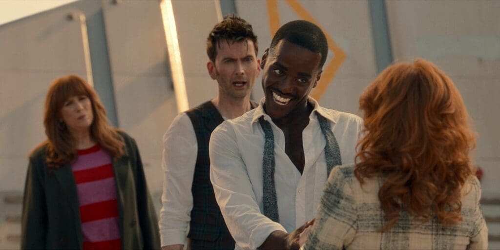 The 15th Doctor, talking to Mel, the 14th & Donna in the background