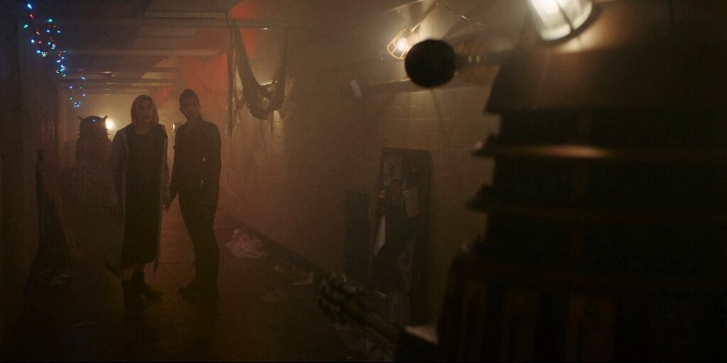 The Doctor and Yaz surrounded by Daleks