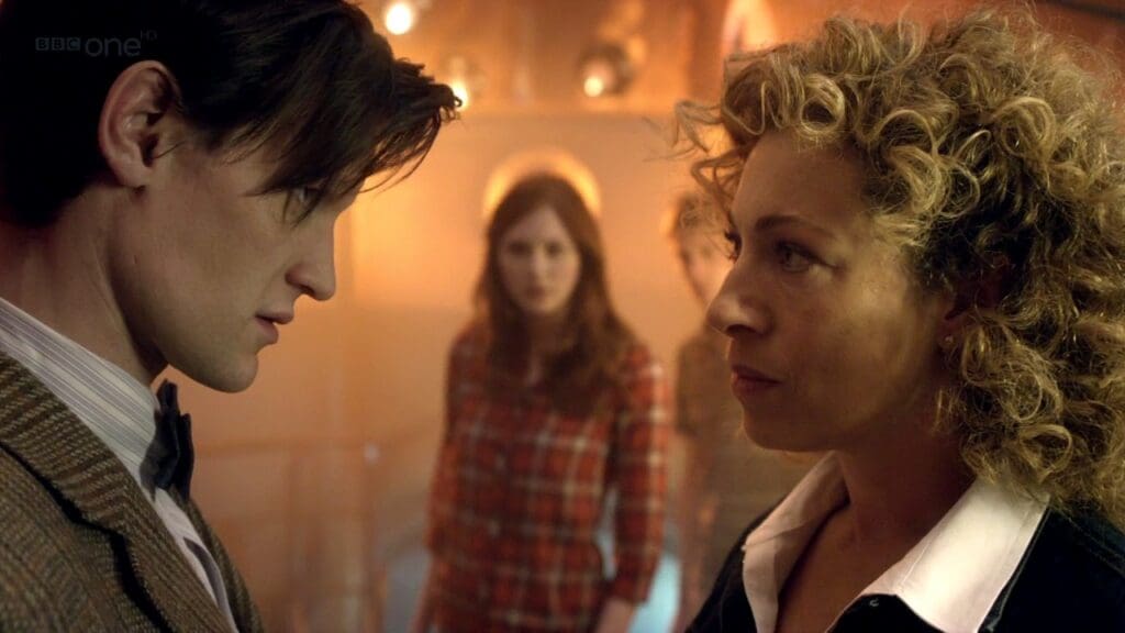The Doctor, talking to River. Amy is in the background.