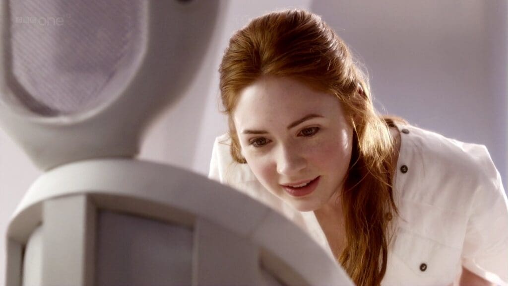 Amy Pond, looking down at her baby