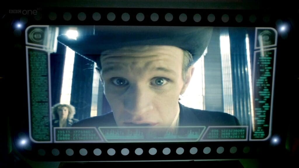 The Doctor in a top hat, on a view screen