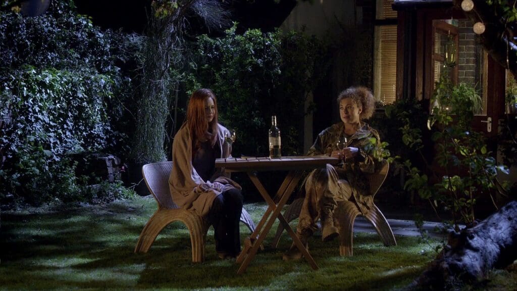 Amy and River, in the garden together drinking wine